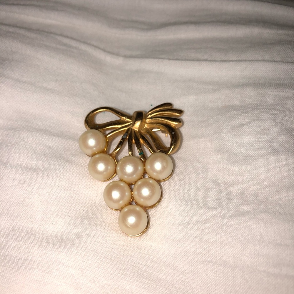 Pearl brooch on front and gold at the back